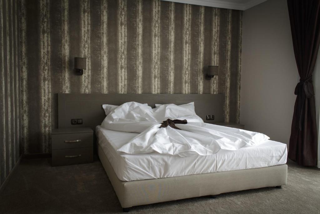 Postel nebo postele na pokoji v ubytování Hotel Nove