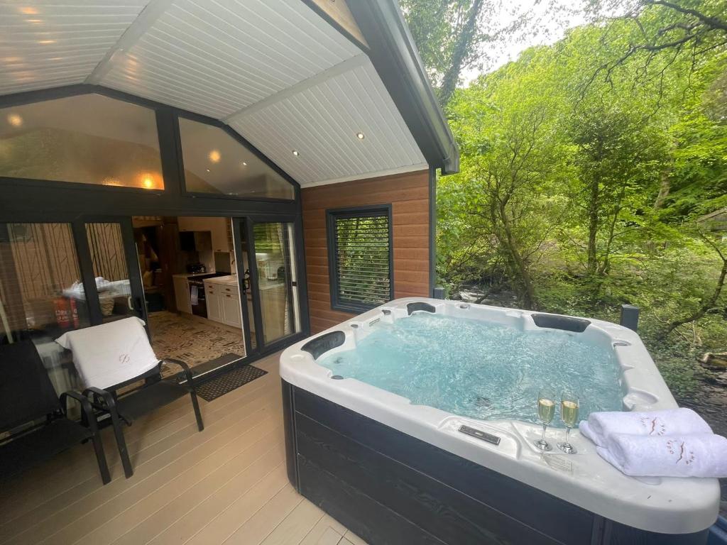 a large bath tub sitting inside of a house at P74 - Riverside Family Pod with Hot Tub in Bethesda