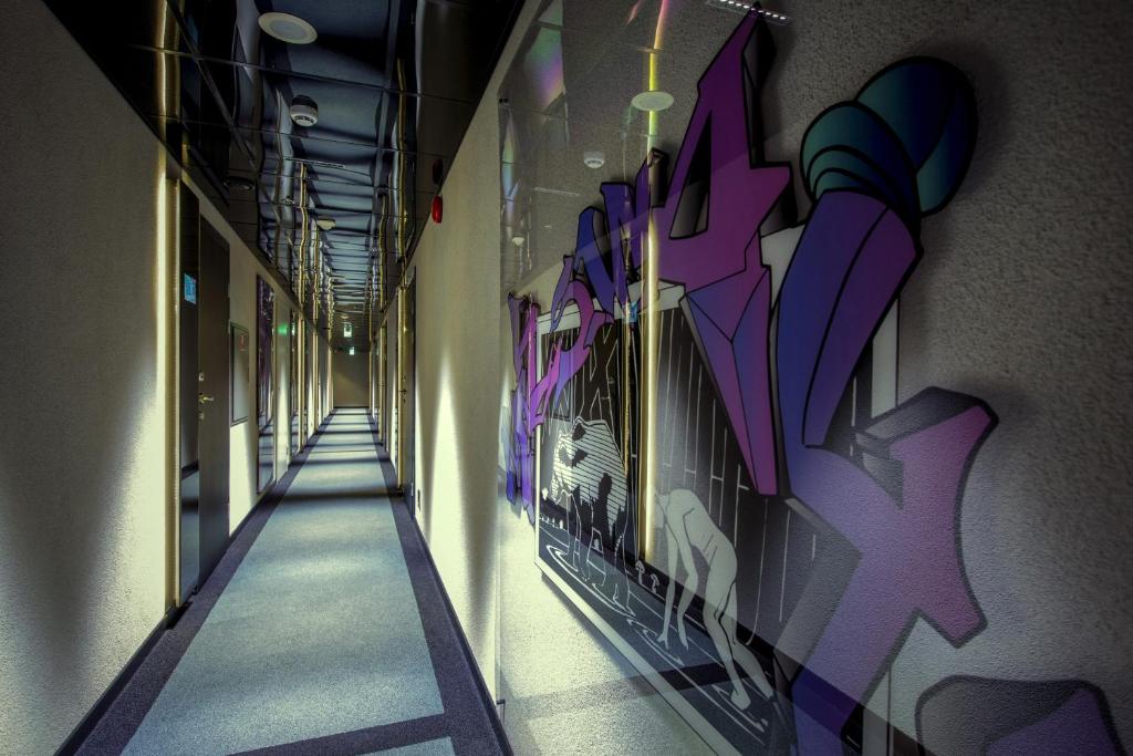 a hallway with graffiti on the walls of a building at Hotel Klaus K in Helsinki