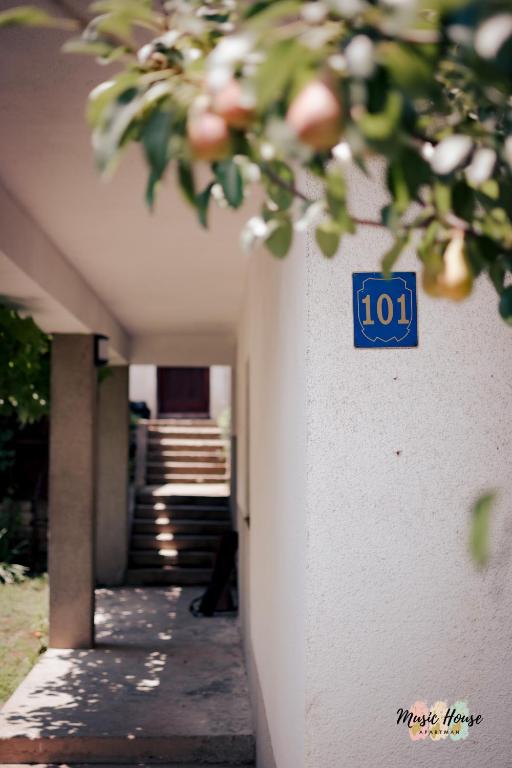 a blue sign on the side of a building at Music House Apartment in Tuzla