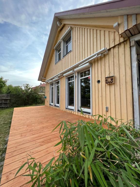 a wooden deck in front of a house at Haus Krönchen in Tanne