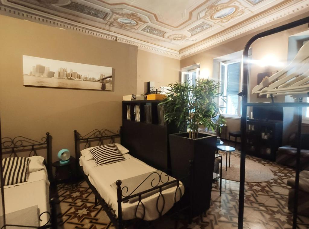 a bedroom with a bed and a plant in it at Via Verdi 5, Gli Affreschi in Monterosso al Mare