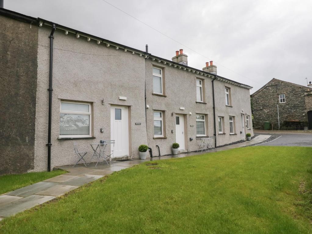 a house with a lawn in front of it at Oxen Park Farm Cottage in Ulverston