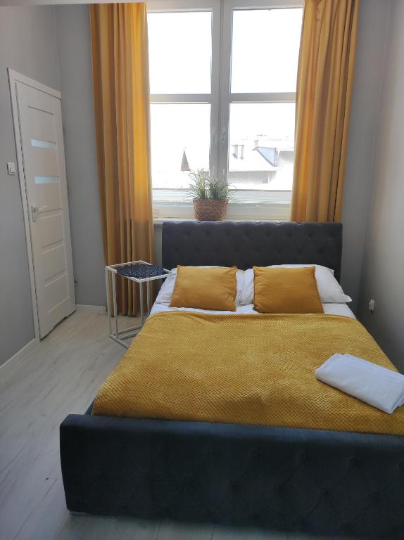 a bed in a bedroom with a large window at MALTINA in Malbork
