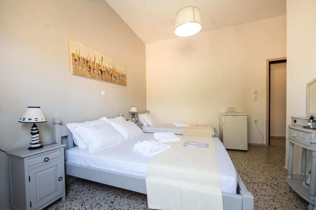 Un dormitorio con una gran cama blanca y una mesa en Giasemi Room No 4 Anafi en Livadi Astypalaias