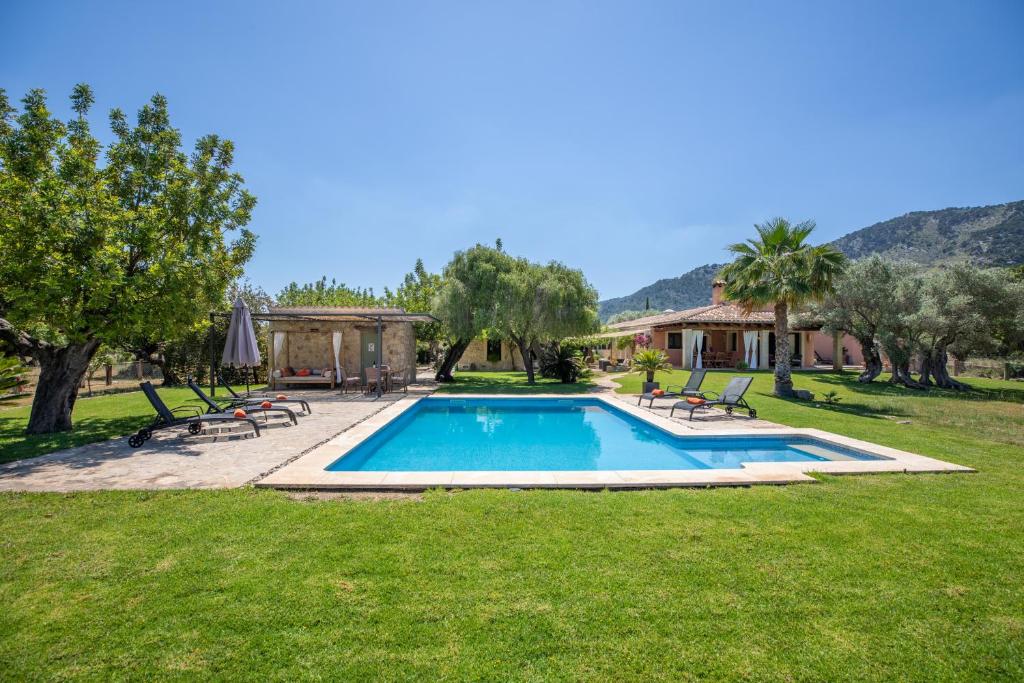 a swimming pool in the middle of a yard at Selva - 38903 Mallorca in El Port de la Selva