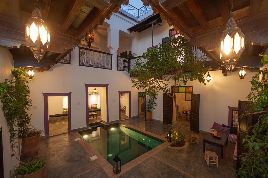 an indoor pool in the middle of a building at Dar Le Fennec in Marrakesh