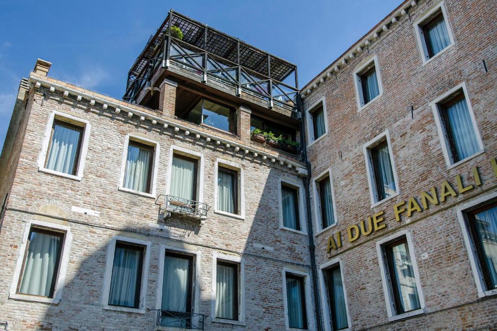 a brick building with a fire tower on top of it at Ai Due Fanali Adults Only in Venice