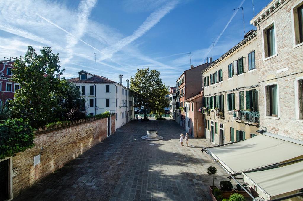 an empty street in a city with buildings at Ai Due Fanali Adults Only in Venice
