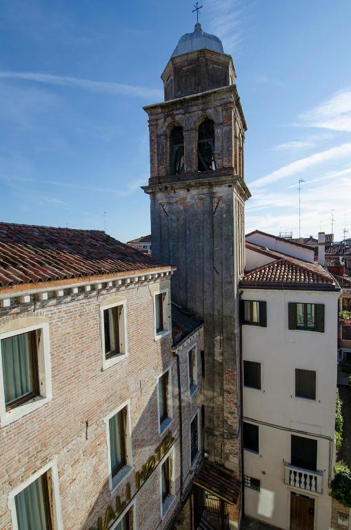 an old tower with a clock on top of a building at Ai Due Fanali Adults Only in Venice