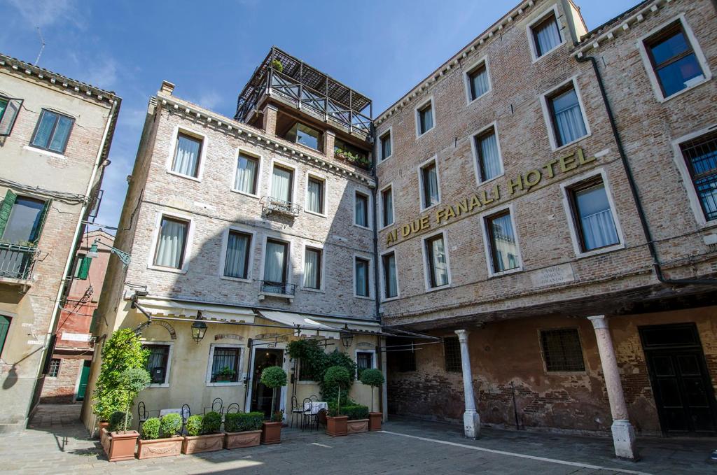 a row of brick buildings in a street at Ai Due Fanali in Venice