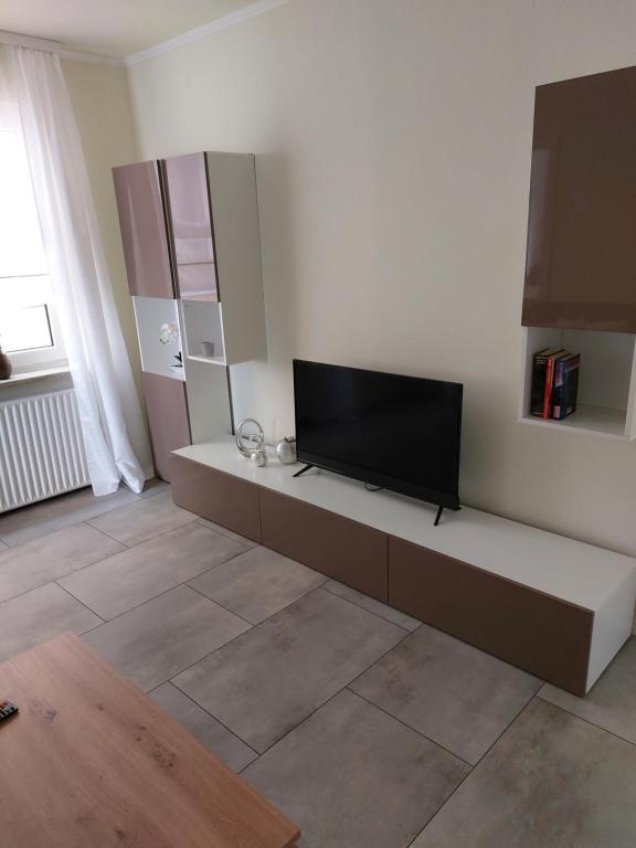 a living room with a flat screen tv on a wall at Ferienwohnung Thamm in Lage