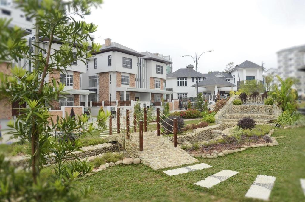 a garden in front of a building with houses at Zinnia Residences in Cameron Highlands