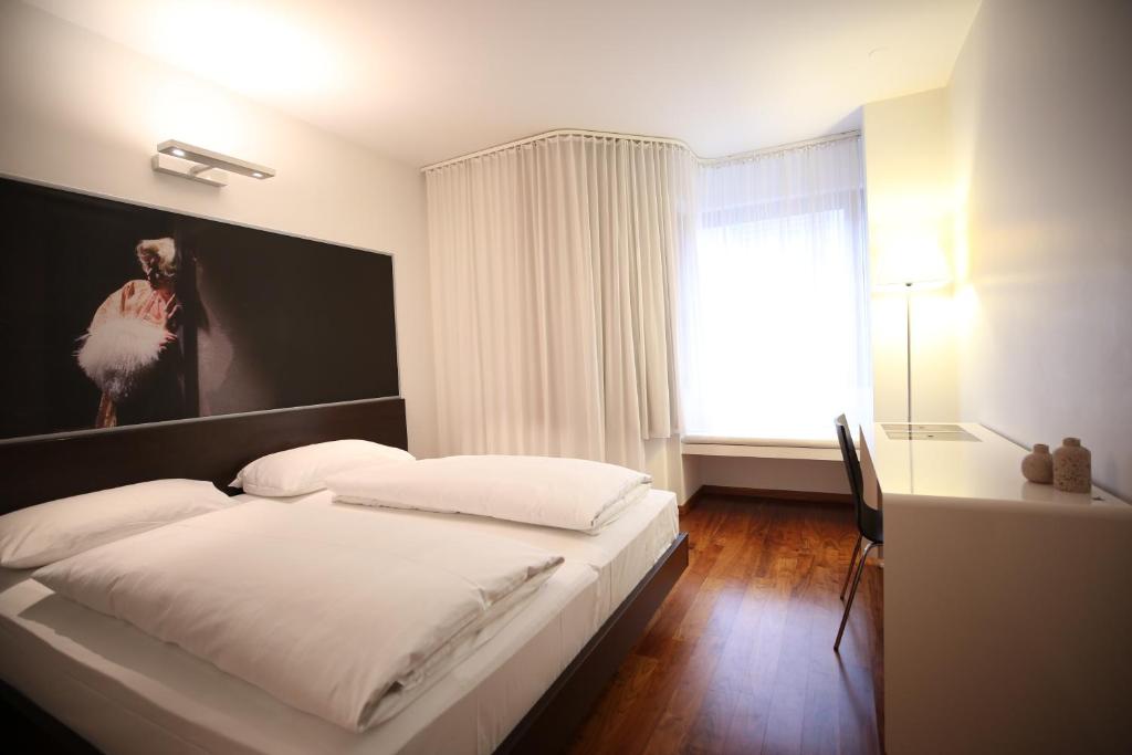 Postel nebo postele na pokoji v ubytování arte Hotel Linz