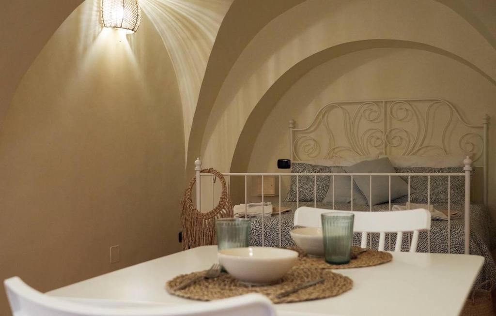 a white table with two chairs and a bed at Blu Bari in Bari