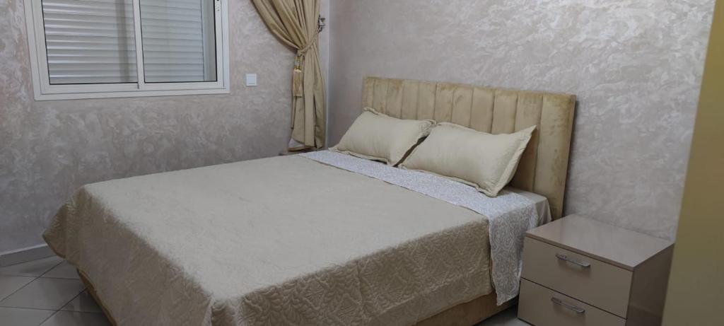 a bedroom with a bed and a window at Hay salam réservé aux familles in Agadir