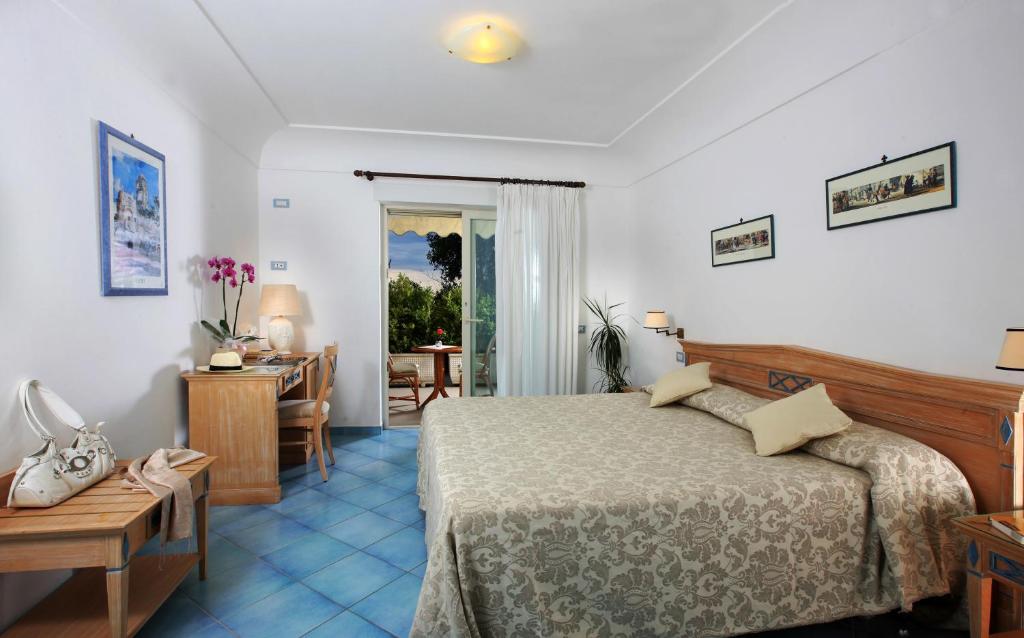 Postel nebo postele na pokoji v ubytování Hotel Al Mulino