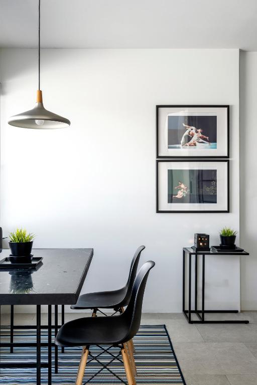 A compact dining or work table set against a styled wall with artwork.