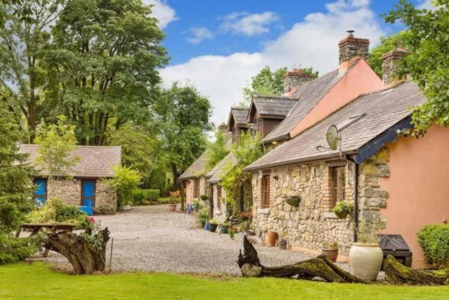 a stone house with a gravel driveway in a yard at Catstone Lodge 