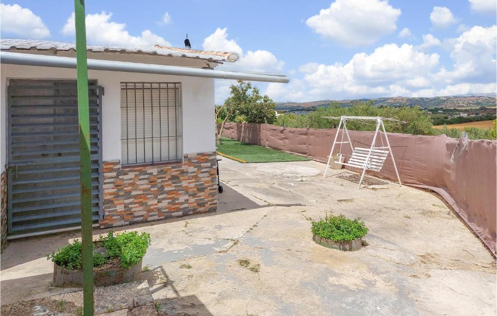 a house with a yard with a swing at Stunning Home In Arcos De La Frontera in Arcos de la Frontera