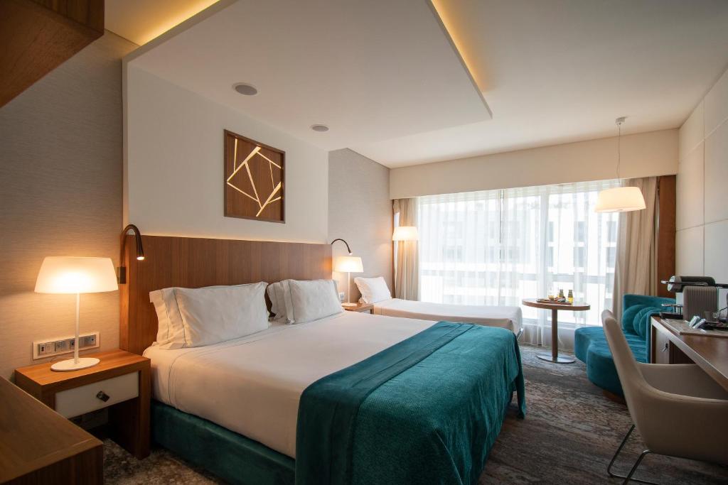 A double room with a bright glazed frontage, work area, and compact seating corner.