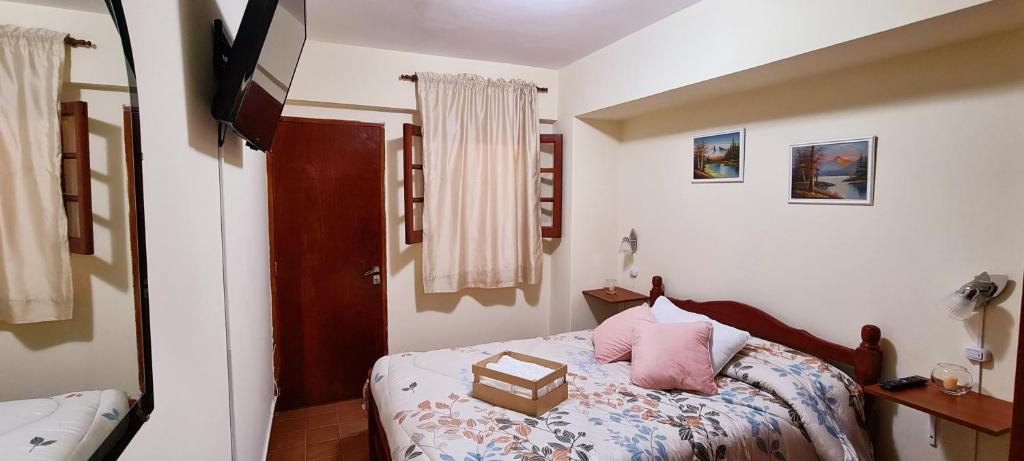 a bedroom with a bed with a box on it at SOYSOL.DEPARTAMENTOS in San Salvador de Jujuy