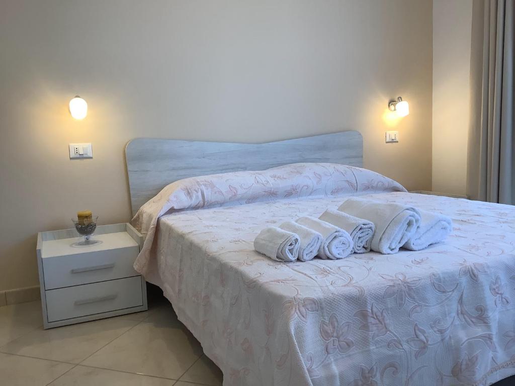 a bedroom with a bed with towels on it at Da Cristina Con Amore in Taormina