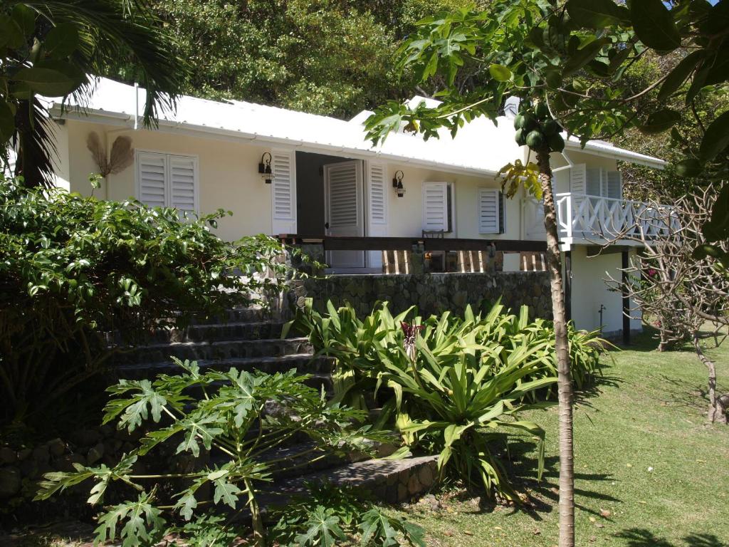 a house in the middle of a garden at Firefly Estate Bequia in Crescent Beach