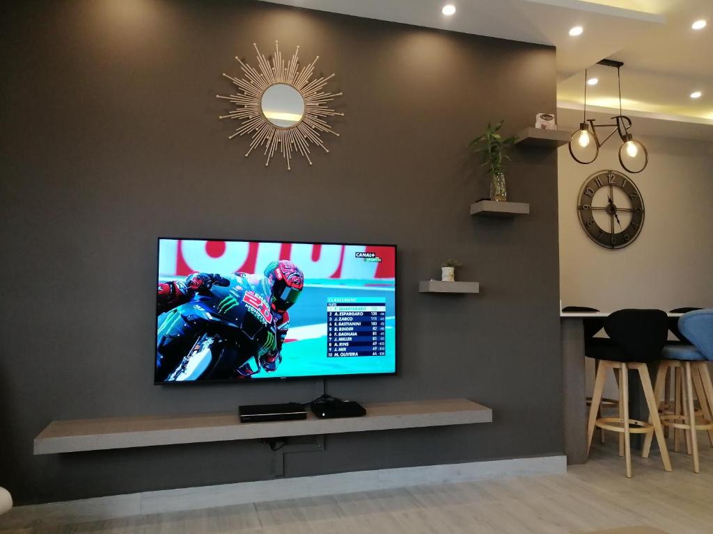 a flat screen tv on a wall in a living room at VH Newave holiday in Flic-en-Flac