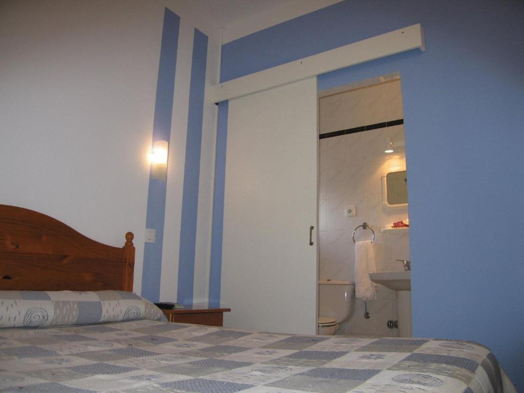 Postel nebo postele na pokoji v ubytování Hospedaje Luciano