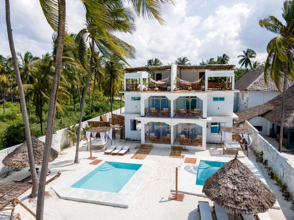 an aerial view of a villa with a swimming pool and palm trees at Coco Rise Villas - by Hostly in Bwejuu