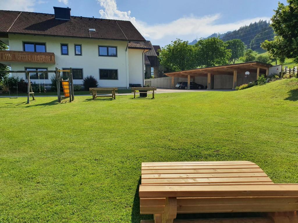 a park with two benches and a building at Eiblhof in Schladming