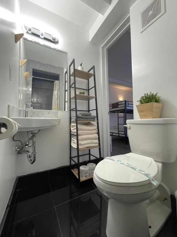 a bathroom with a toilet and a sink at Hotel and the City, Rooftop City View in New York