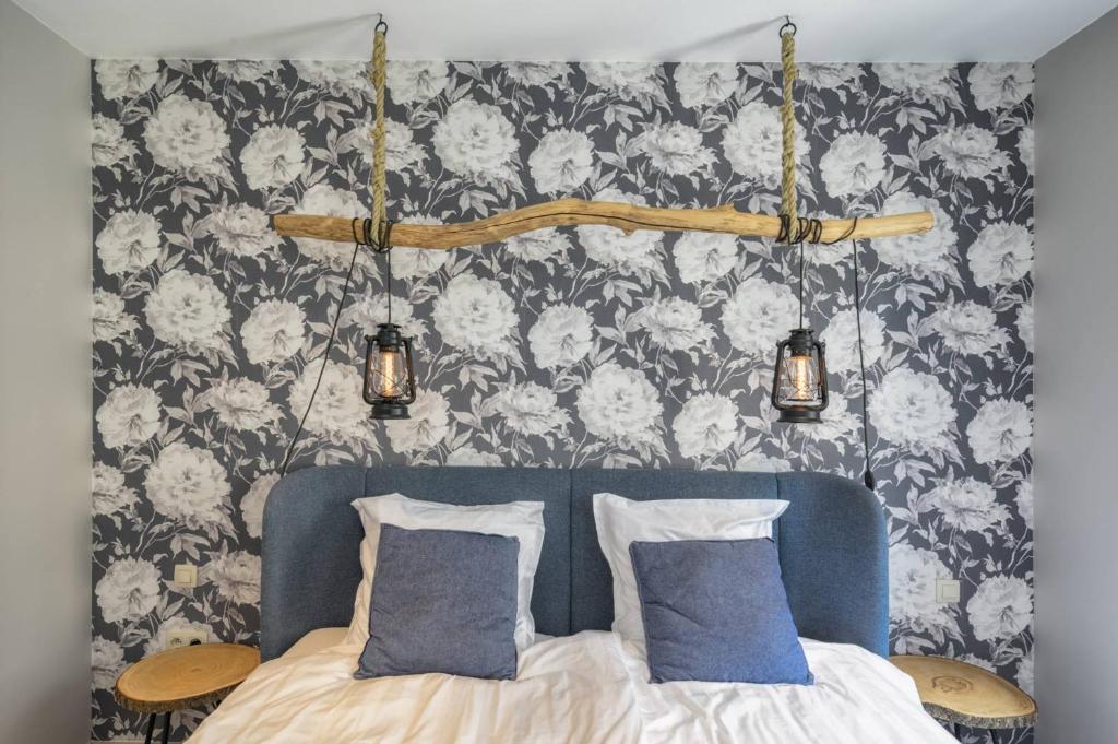 sypialnia z łóżkiem z 2 niebieskimi poduszkami w obiekcie Poortershuys w mieście Ypres