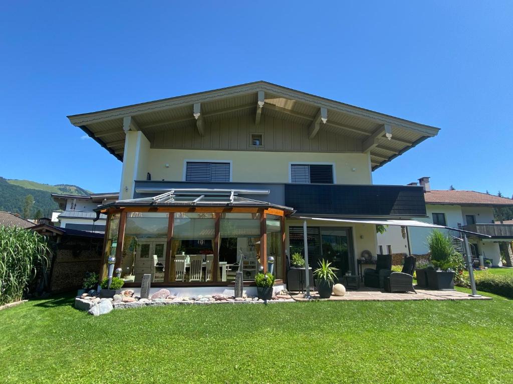 a house with a large glass front yard at Haus am Achengrund in Kössen