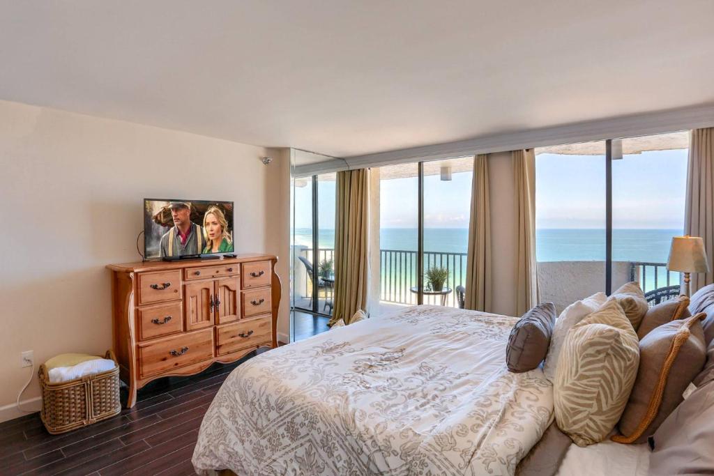 a bedroom with a large bed with a view of the ocean at 1506 Lighthouse Towers in Clearwater Beach