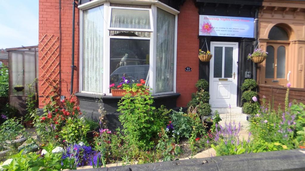 a house with flowers in front of a window at Heavenly Nights Guest House in Sheffield