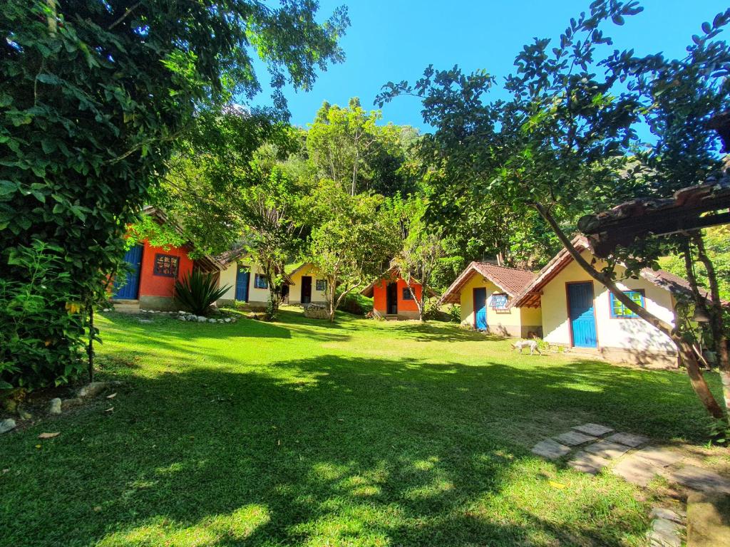 a group of houses in a yard with trees at "Brilho do Sol" in Lumiar