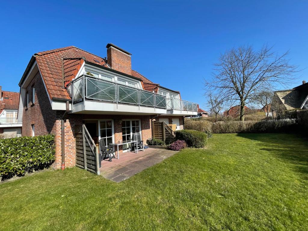 a large brick house with a glass roof at Auszeit in Wangerland