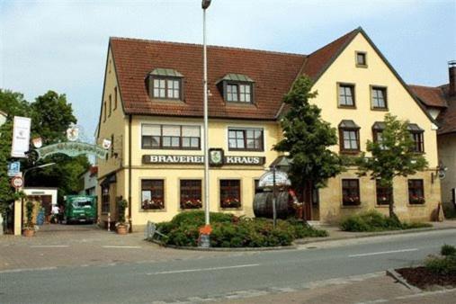 a large yellow building on the side of a street at Brauerei Gasthof Kraus in Hirschaid