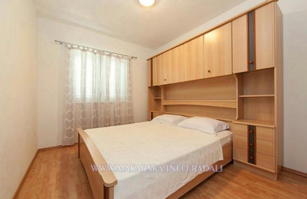 Posteľ alebo postele v izbe v ubytovaní Apartmani IvaMia
