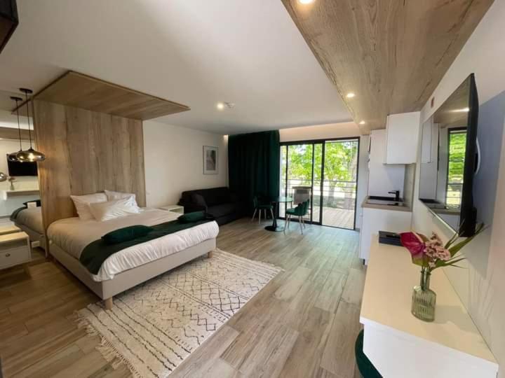 a bedroom with a bed and a living room at O complexe hebergement in Francourt