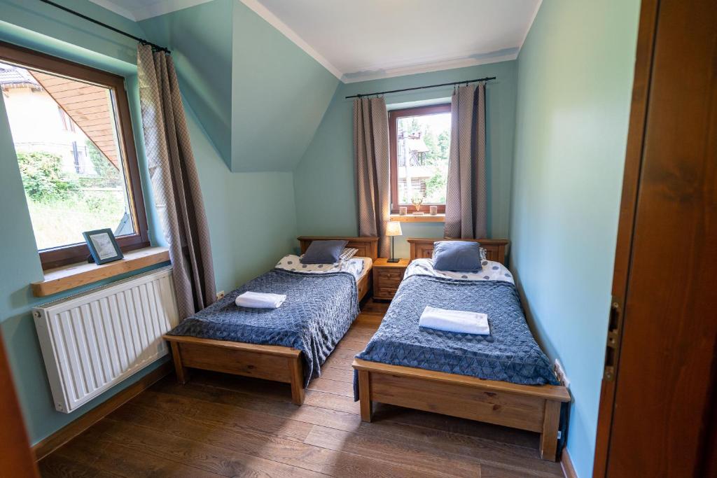 Posteľ alebo postele v izbe v ubytovaní Apartamenty Góralmobile Zakopane