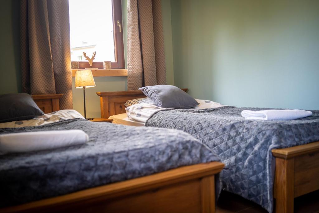 Posteľ alebo postele v izbe v ubytovaní Apartamenty Góralmobile Zakopane