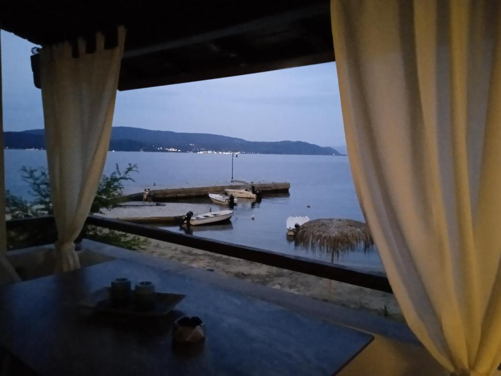 a view of the water from a room with a window at IRENE traditional apartments in Ammouliani