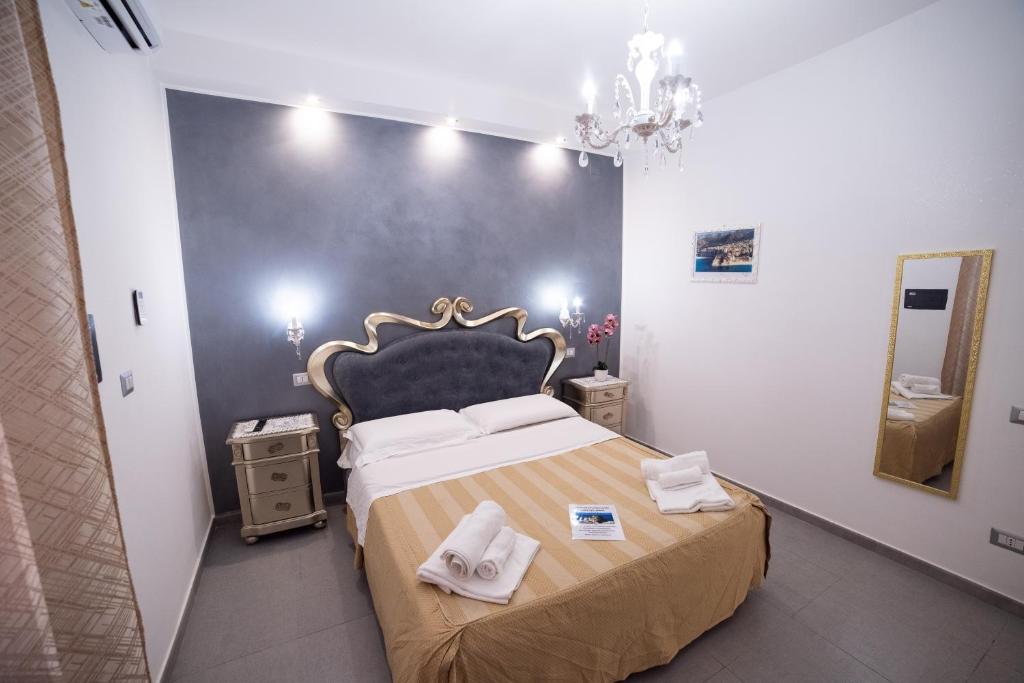 a bedroom with a large bed with towels on it at Residenza Luce Sul Mare in Tropea