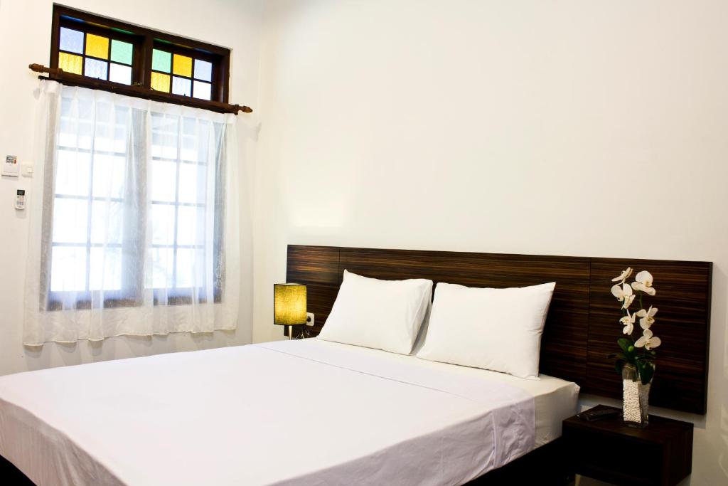 Postel nebo postele na pokoji v ubytování Grand Marto Hotel