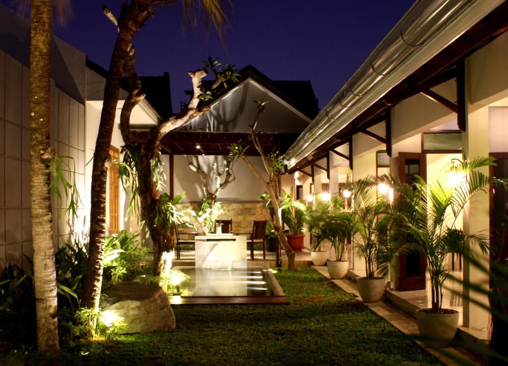 a house with a cat sitting on the roof at night at Grand Marto Hotel in Yogyakarta