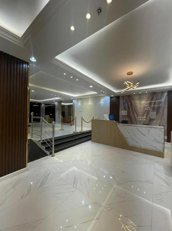 a lobby with a marble floor and a staircase at فندق اريف in Abha
