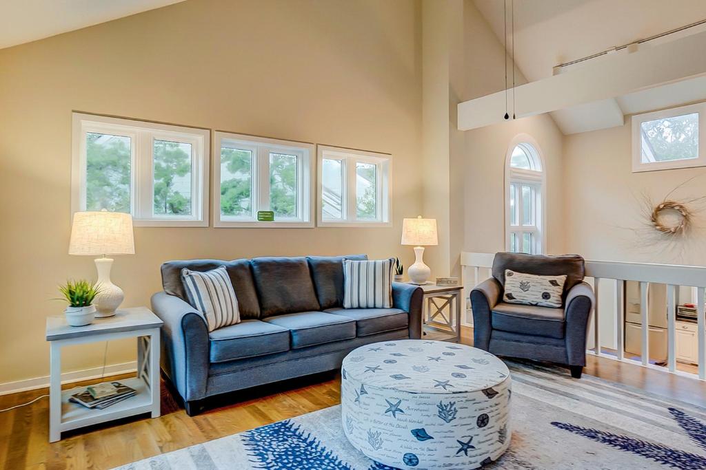 a living room with a couch and two chairs at Seabrook Sanctuary - 1706 Courtside in Seabrook Island